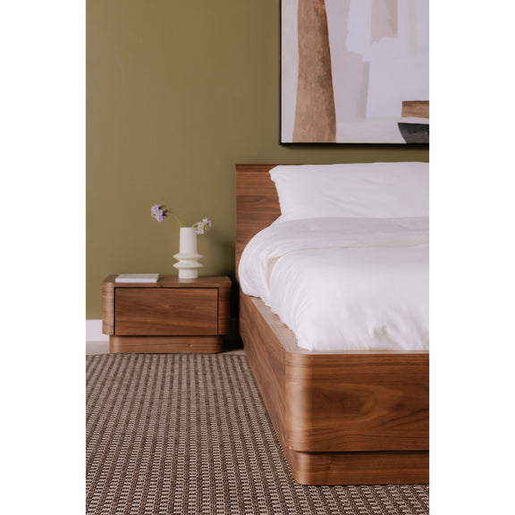 Queen bed frame in natural walnut with low side rails and neatly made white duvet