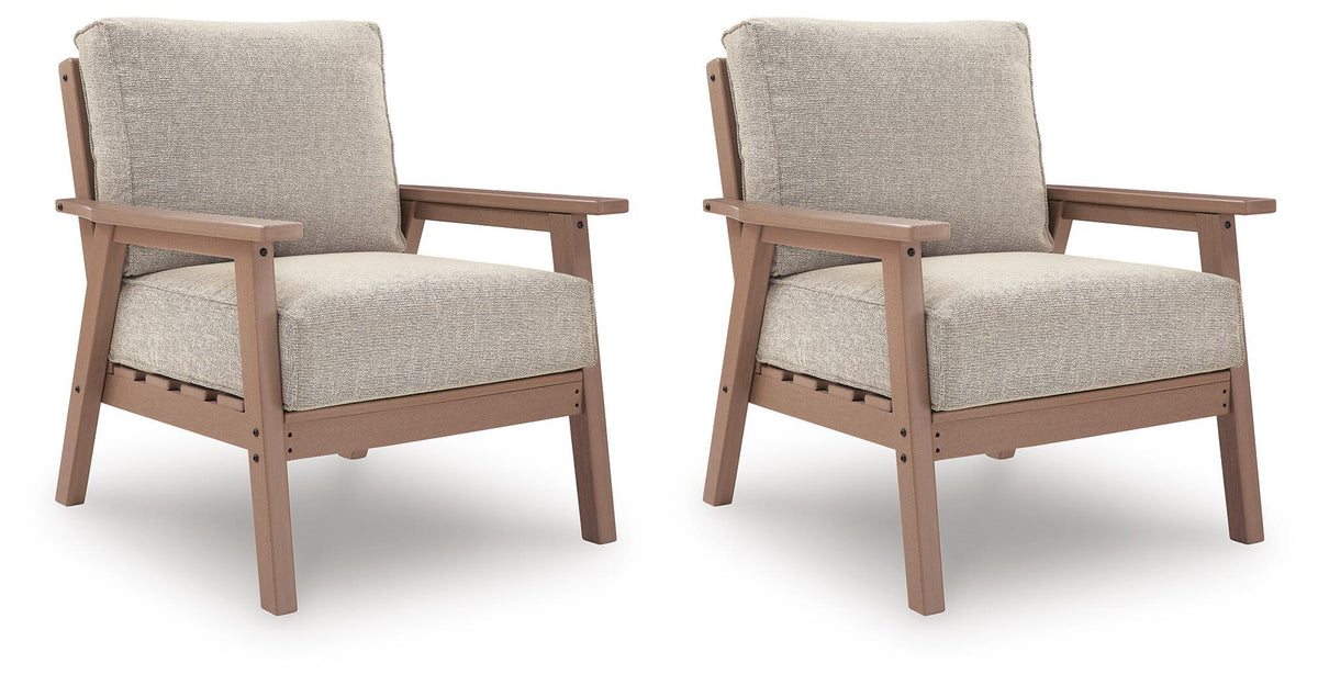 Pair of beige lounge chairs with driftwood frames and fabric seat and back cushions