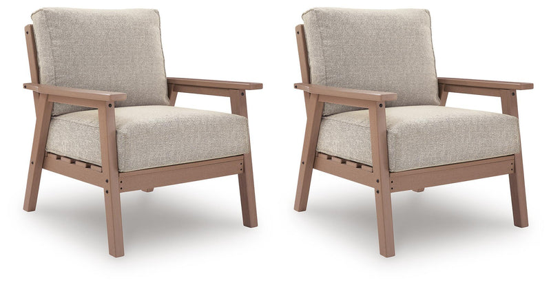 Pair of beige lounge chairs with driftwood frames and fabric seat and back cushions