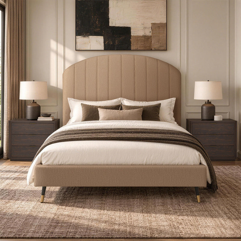 Beige upholstered bed with arched channel headboard, white bedding, and dark throw