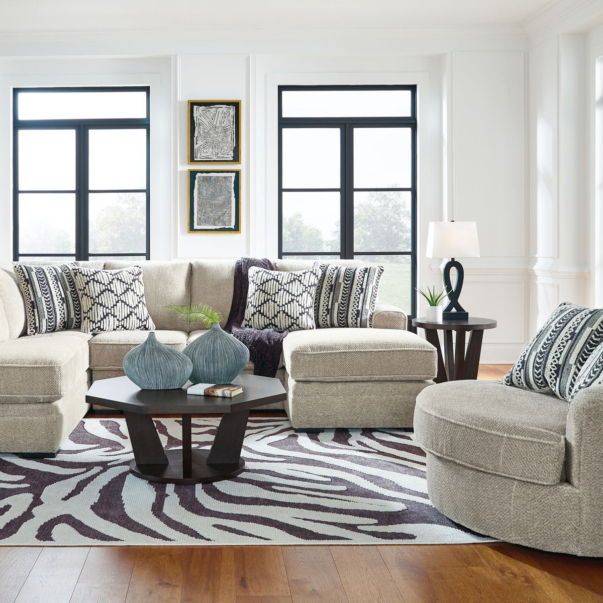 Beige corner chaise sectional sofa with chaise ottoman and patterned throw pillows