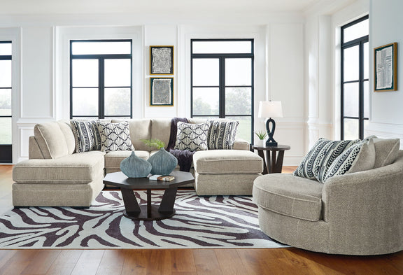 Beige corner chaise sectional sofa with chaise ottoman and patterned throw pillows