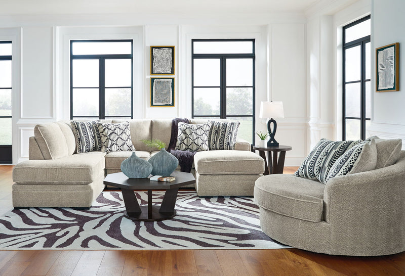 Beige corner chaise sectional sofa with chaise ottoman and patterned throw pillows