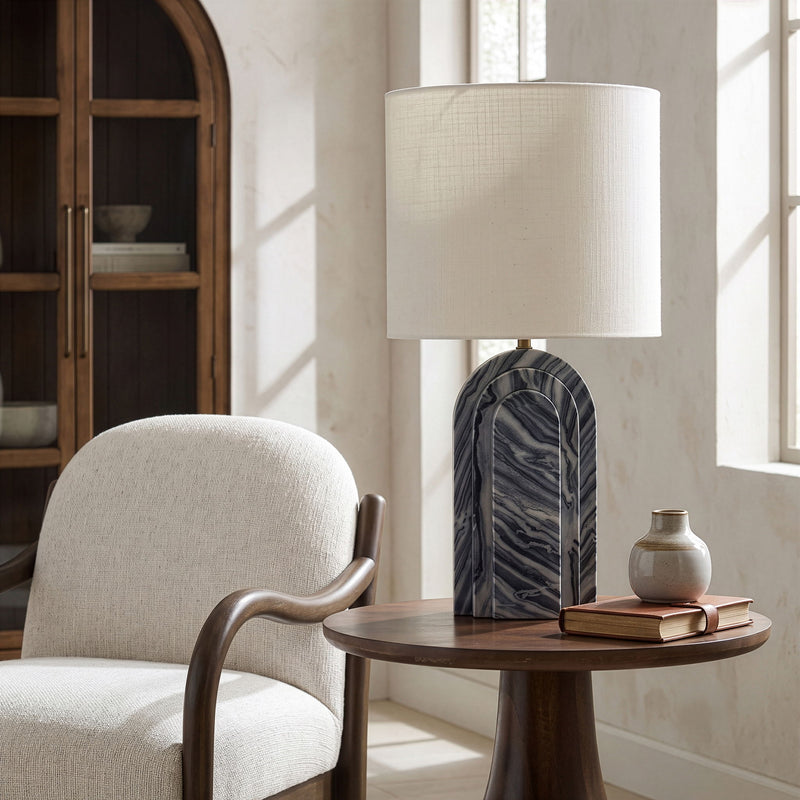Table lamp with white fabric shade and blue-gray stone arched base