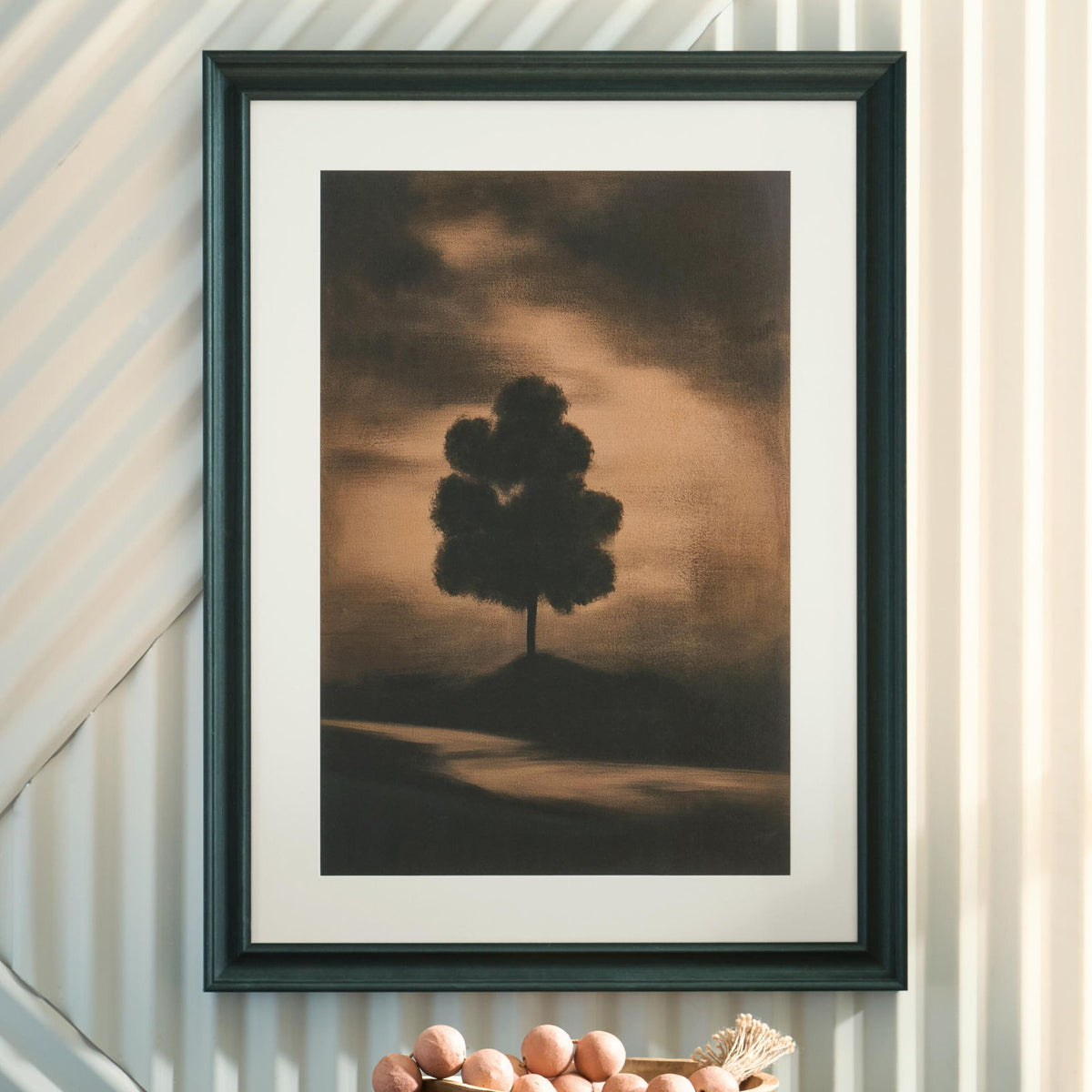 Framed wall art print with lone tree silhouette on muted sunset landscape