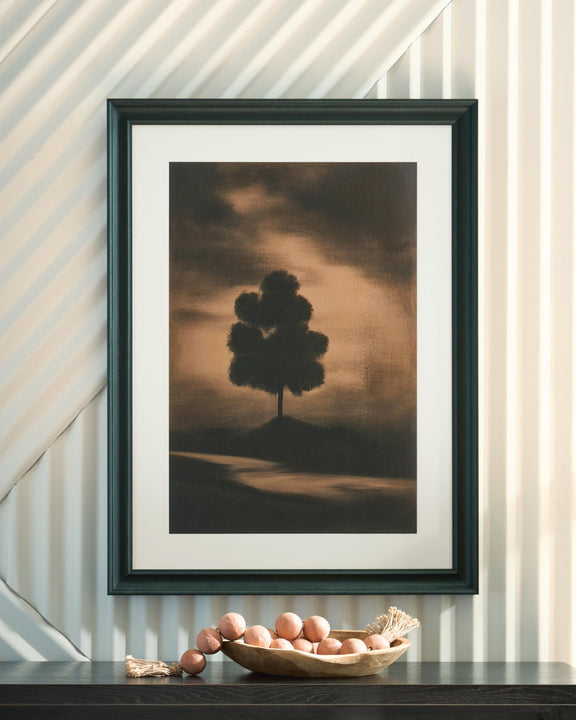 Framed wall art print with lone tree silhouette on muted sunset landscape