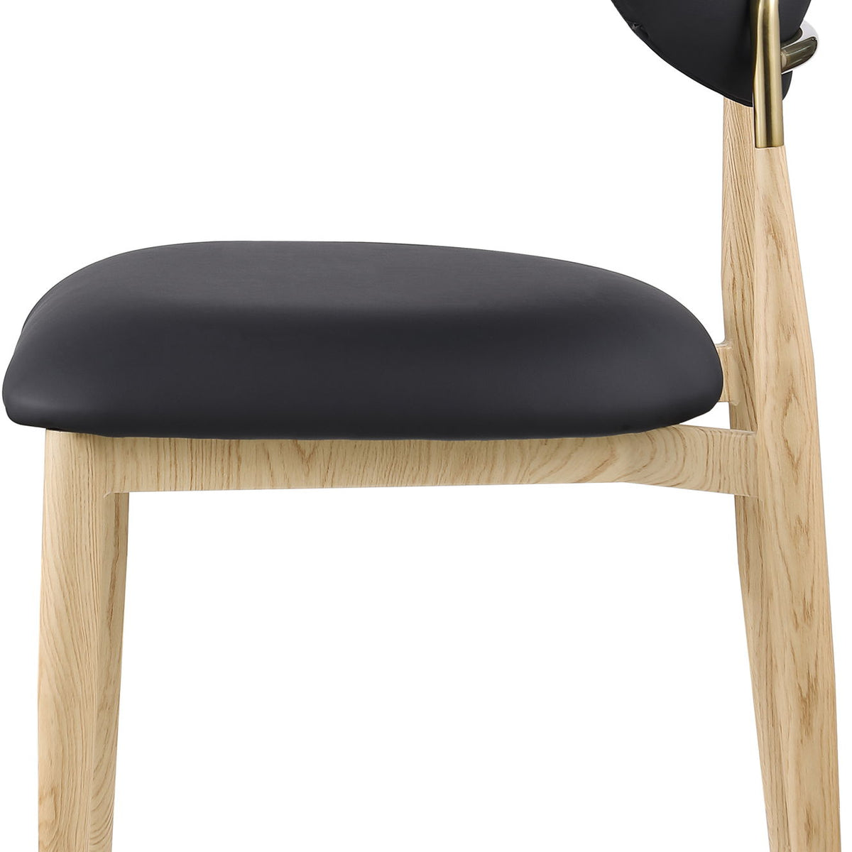 Dark upholstered dining side chair close-up with light wood legs and brass accents