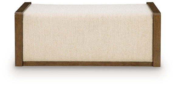 Beige upholstered storage ottoman with brown wooden base and squared edges