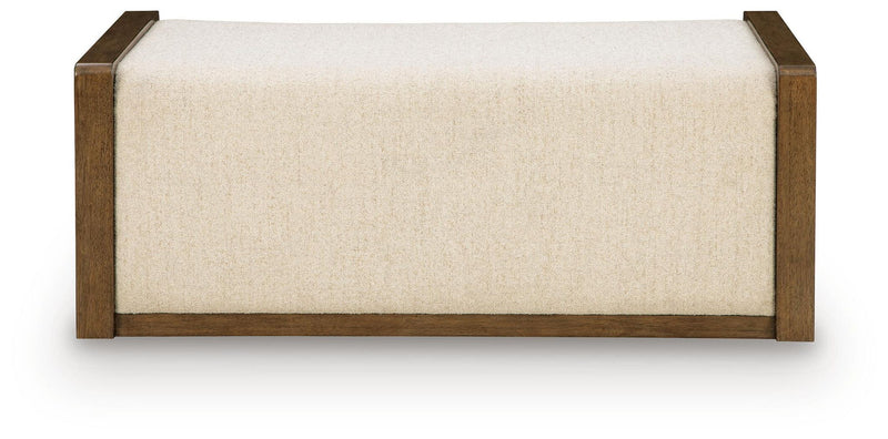 Beige upholstered storage ottoman with brown wooden base and squared edges