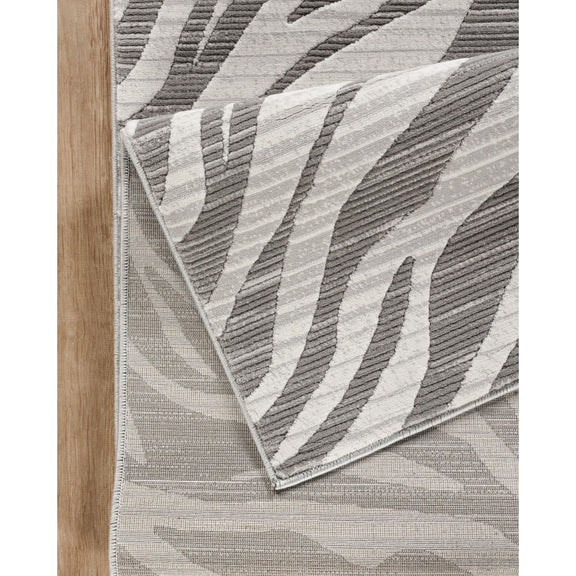 Gray wave-pattern area rug with textured geometric ridges and stitched edge