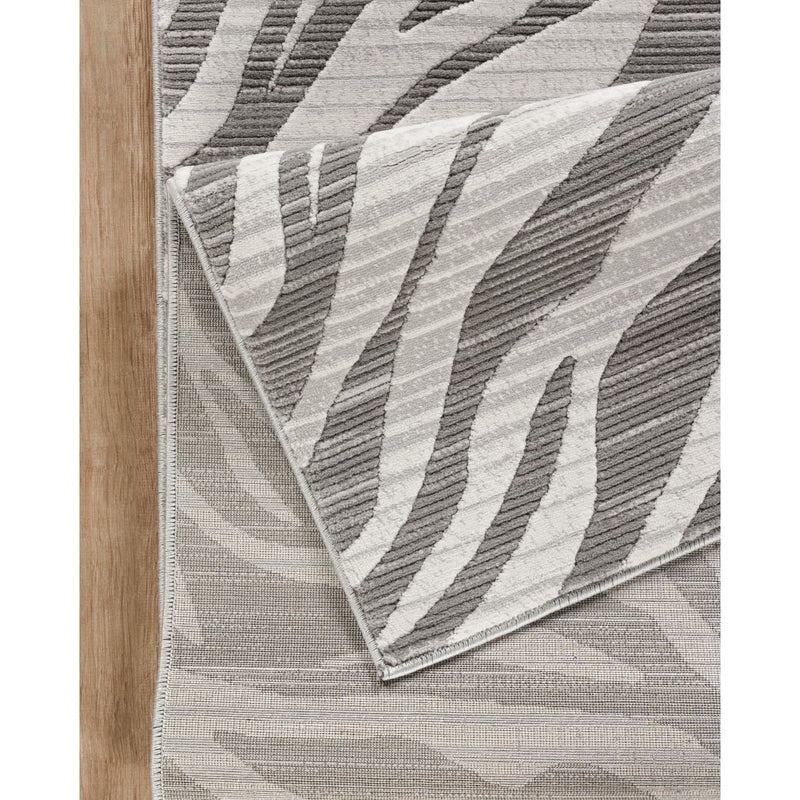 Gray wave-pattern area rug with textured geometric ridges and stitched edge