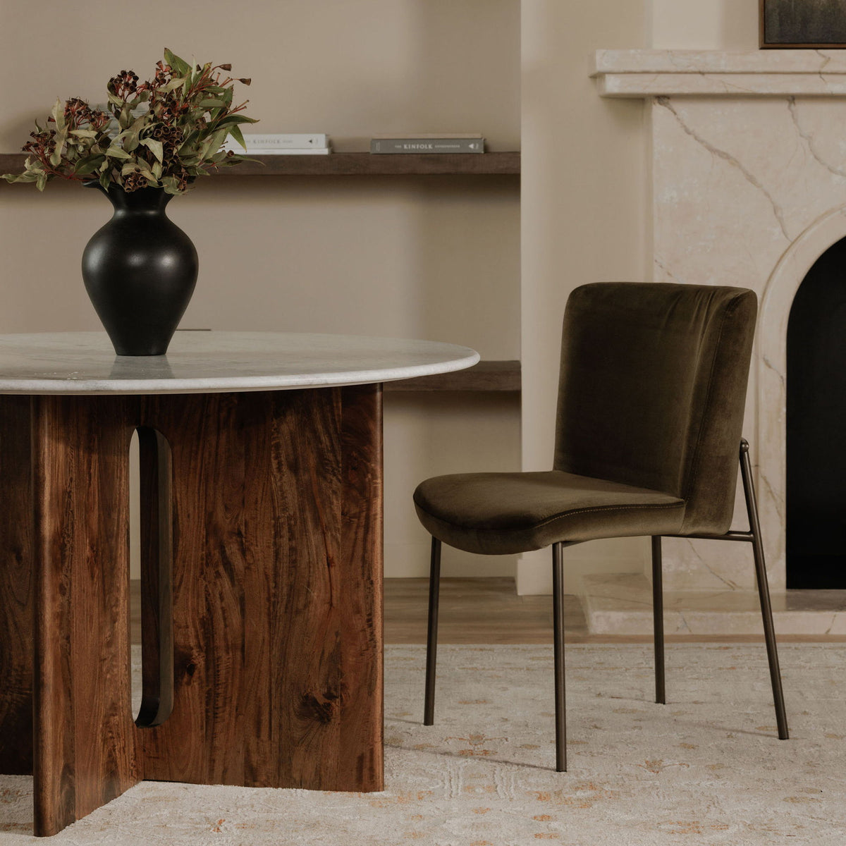 Green dining chair with a padded seat, curved back, and slim metal frame