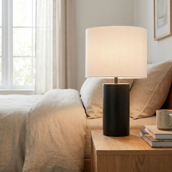 Black table lamp with on/off switch block base and white fabric drum shade