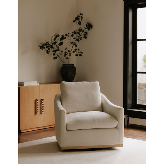 Beige fabric swivel armchair with thick seat cushion and wooden base