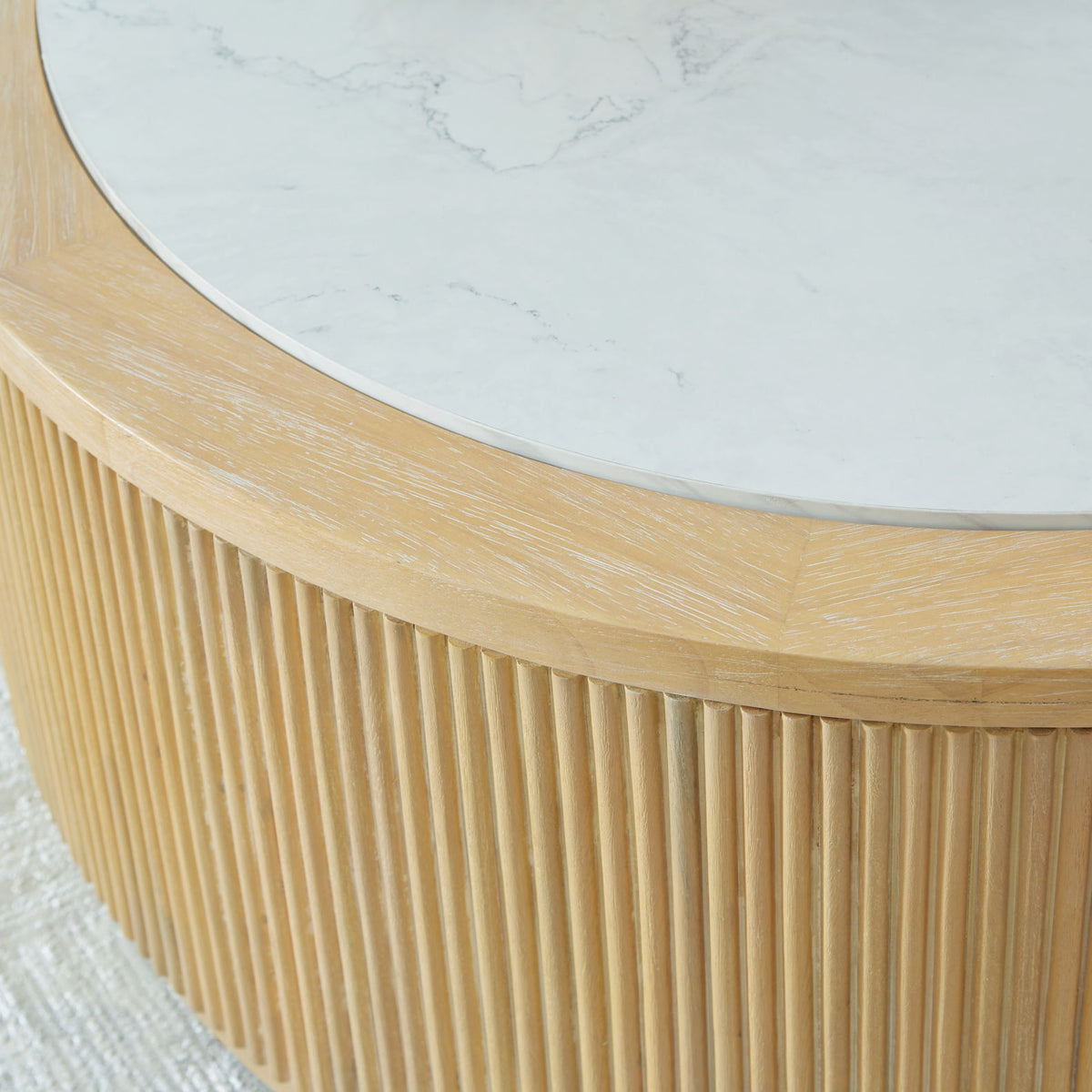 Light brown ribbed side of round cocktail table with white marble edge