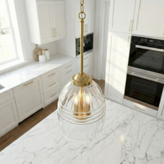 Clear glass dome pendant with gold top and three candle-style bulbs on a chain