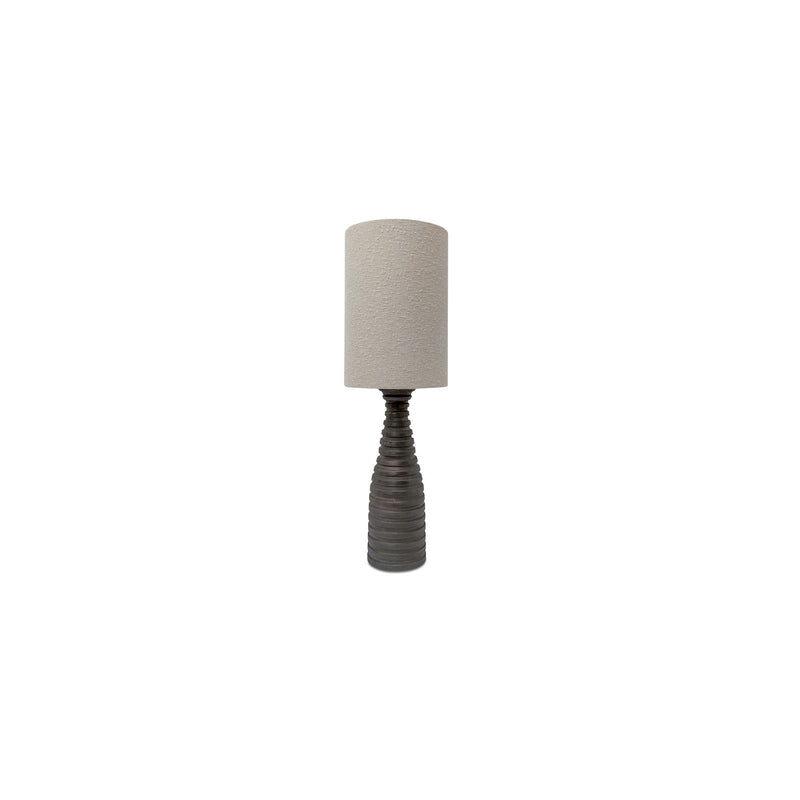 Table lamp with textured beige cylinder shade and dark ribbed pedestal base