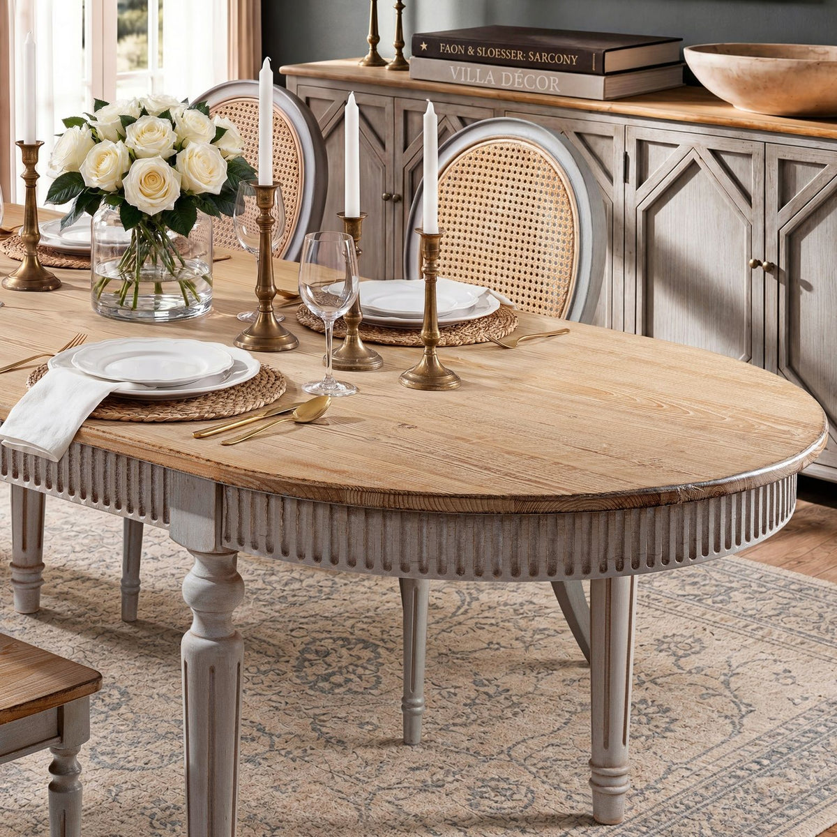Oval dining table with wood slat top and gray pedestal legs