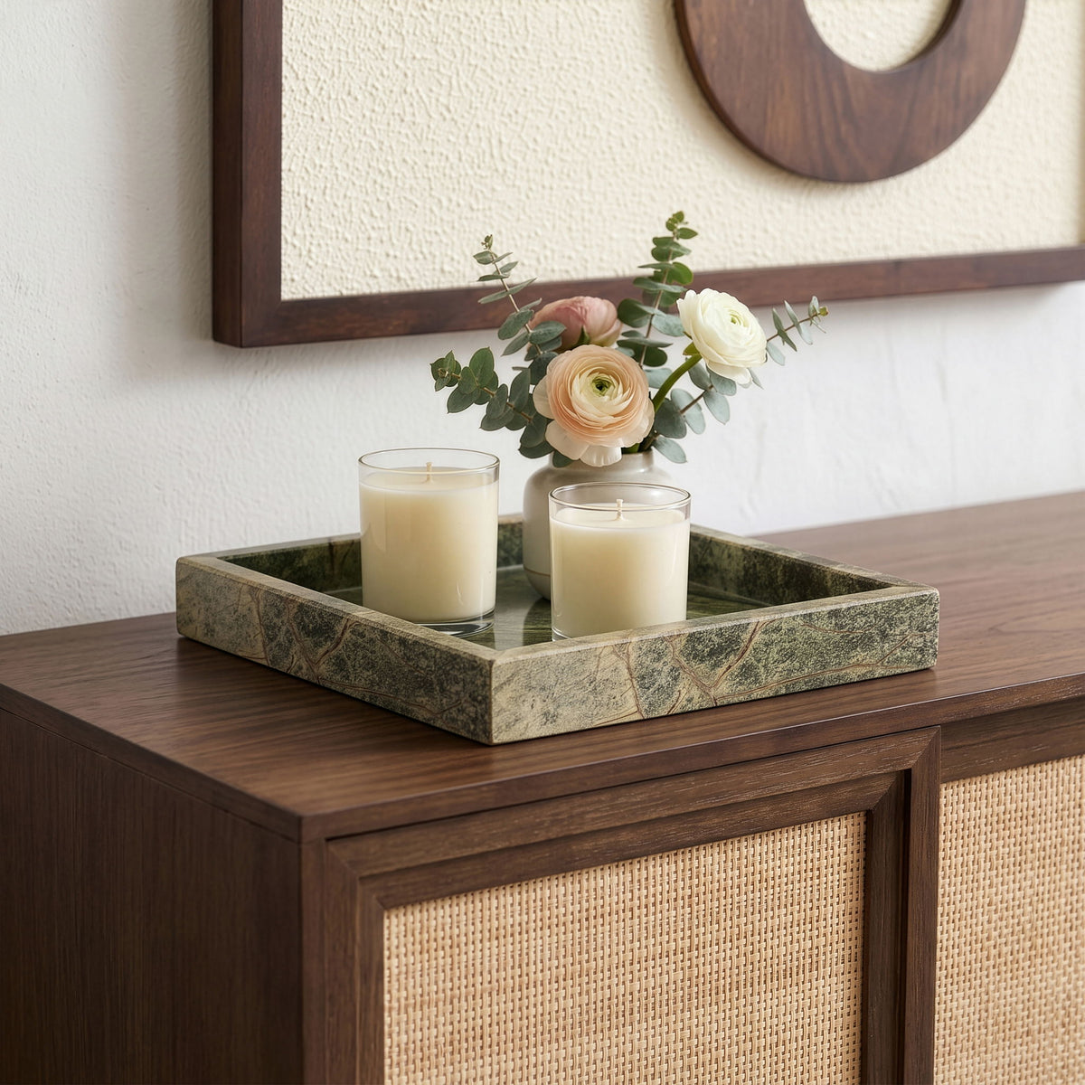 Green marble tray with clear glass insert on tabletop, styled with candles.