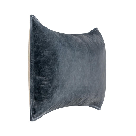 Blue leather lumbar pillow side view with center seam and curved edge.