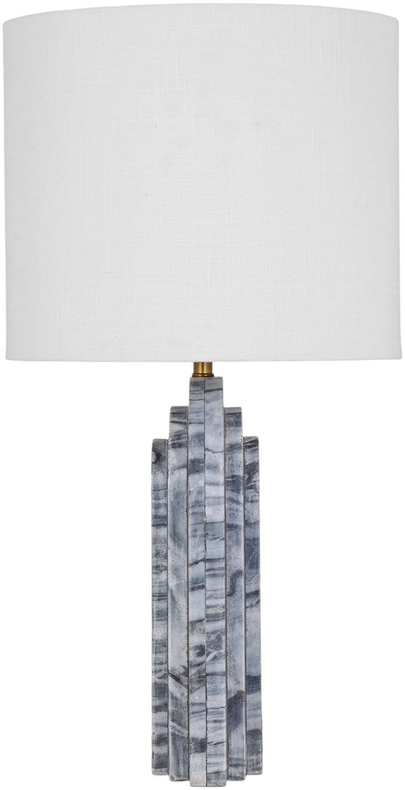 Table lamp with white fabric shade and gray stone stacked-block base