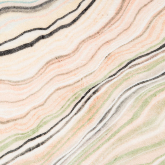 Pillow fabric close-up: cream, green, and blush wavy stripes with black lines