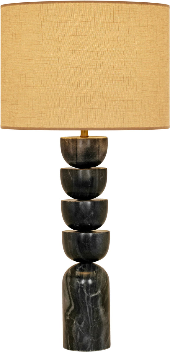 Table lamp with stacked dark marble base and tan fabric drum shade, brass accents