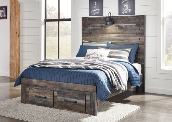 Drystan panel bed with dark wood frame and side drawers, topped with blue bedding and pillows.