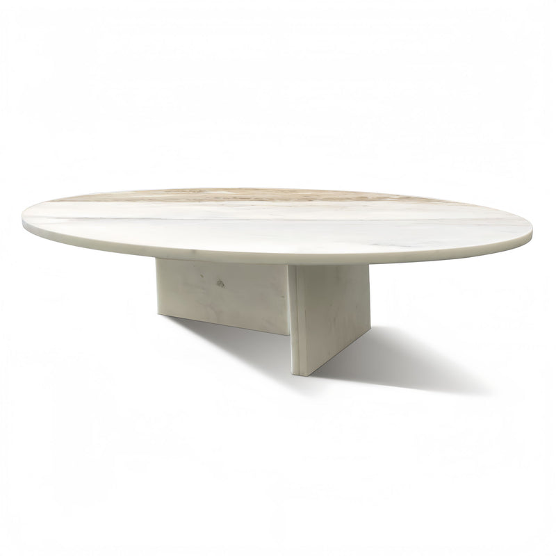 Round stone coffee table with light beige marble top and pedestal base
