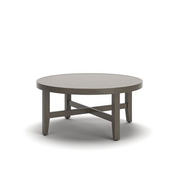 Round cocktail table with a light beige slatted top and brown crossed-leg base