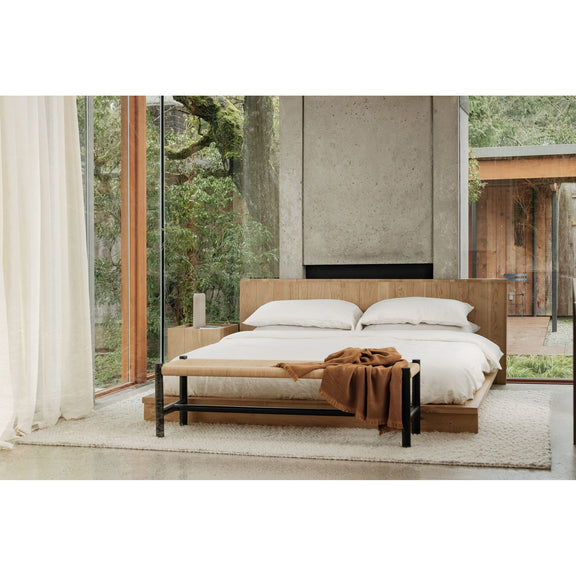Natural oak king bed with curved slatted headboard, white pillows and duvet