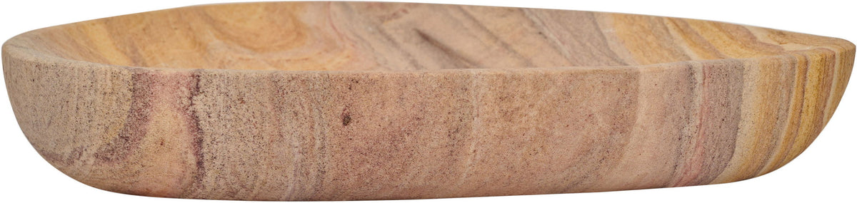 Oval sandstone bowl in sand color with layered tan and brown stone bands.