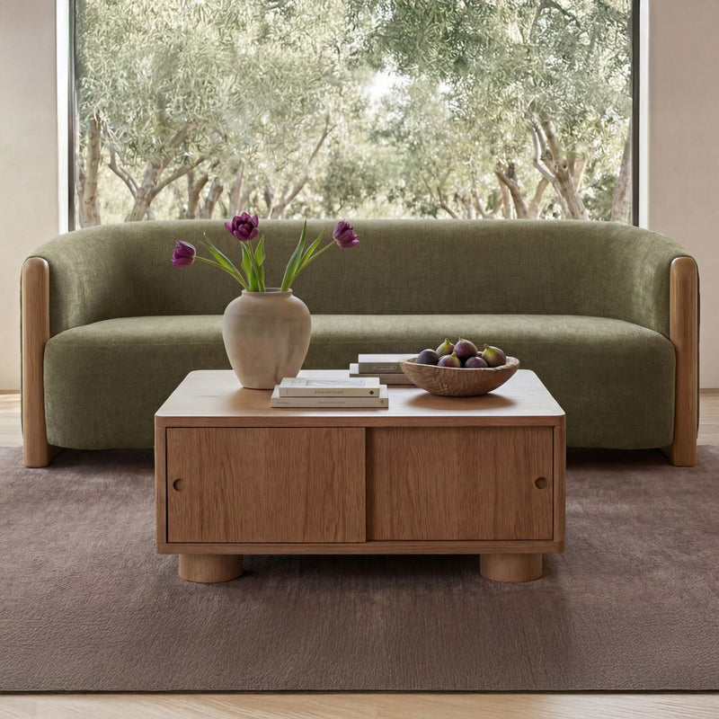 Olive green upholstered sofa with curved back, rounded arms, and wood side panels