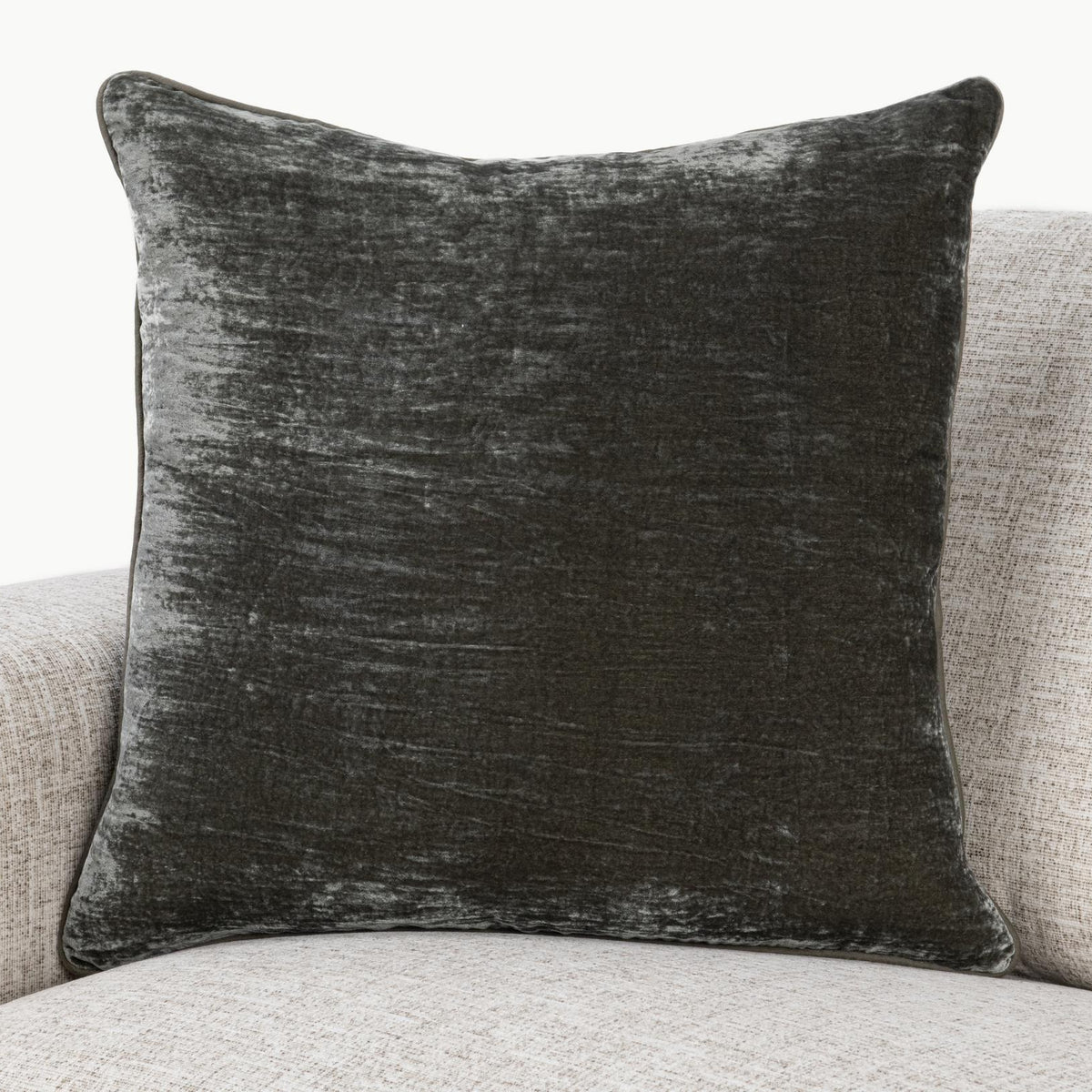Dark gray lumbar pillow with distressed whitewashed pattern and piped seams