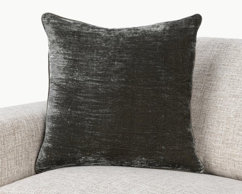 Dark gray lumbar pillow with distressed whitewashed pattern and piped seams
