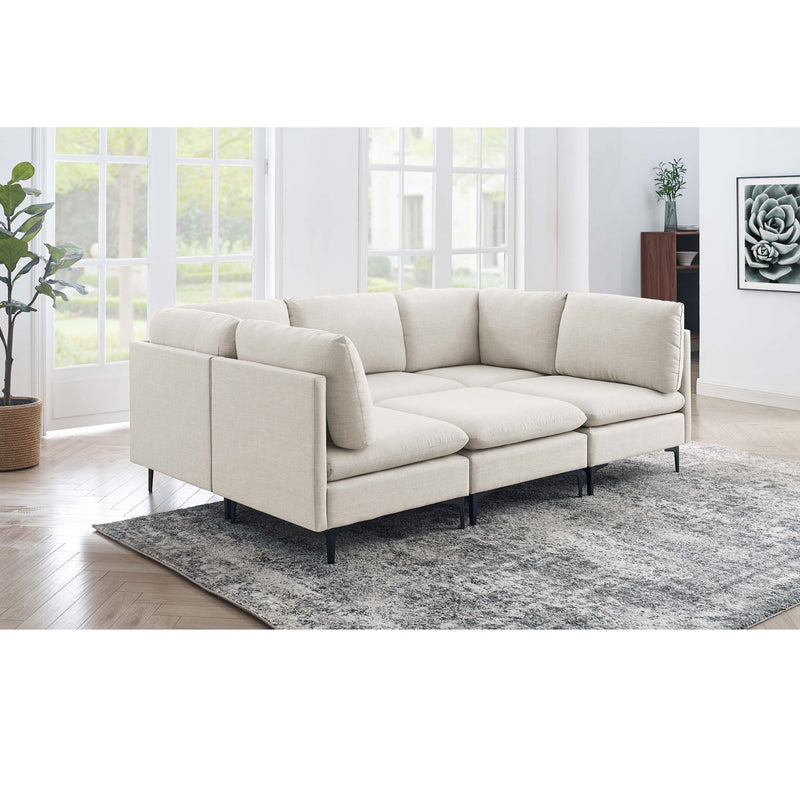 Beige modular upholstered sectional with tall black legs, chaise-style corner