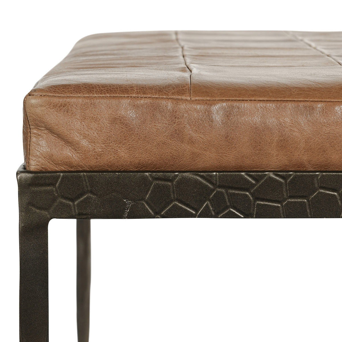 Close-up of leather bench top and textured base skirt on dark legs