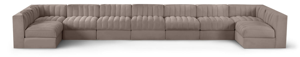 Light beige velvet modular sectional sofa with tufted cushions and curved armrests