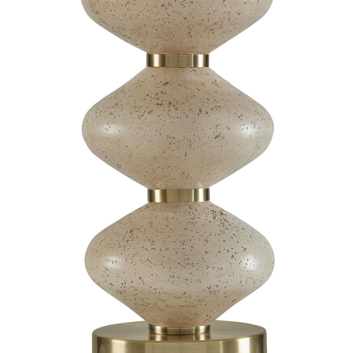 Close-up of stacked speckled beige lamp body with brass top and base