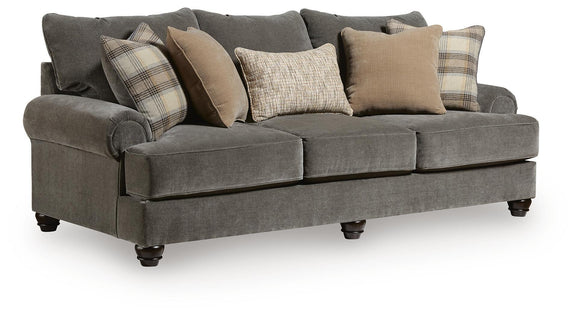 Dark gray fabric sofa with three-seat bench, rolled arms, and mixed throw pillows