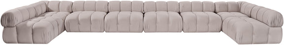 Light gray modular sectional sofa with tufted cushions and rounded corner arms