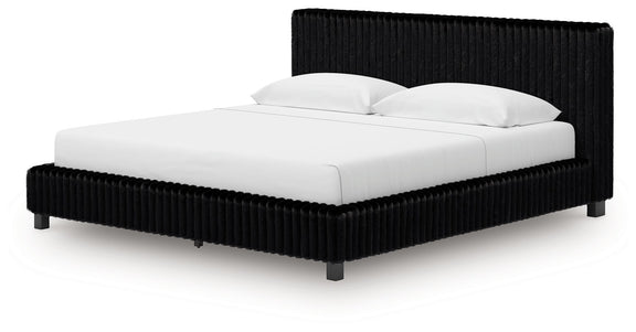 Black upholstered bed frame with ribbed rails, tall headboard, and white bedding.