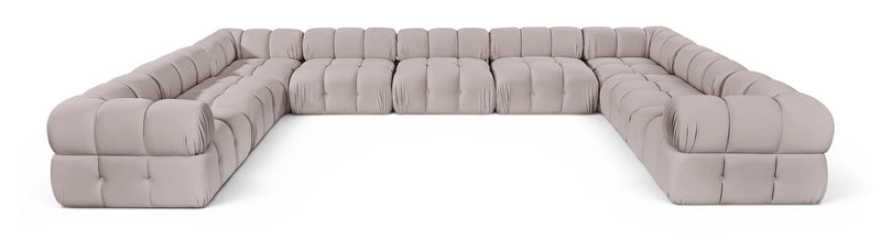 Gray velvet upholstered sectional sofa with tufted seat and curved backrest modules