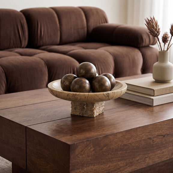 Marble bowl centerpiece on table with stacked pedestal base and decorative spheres