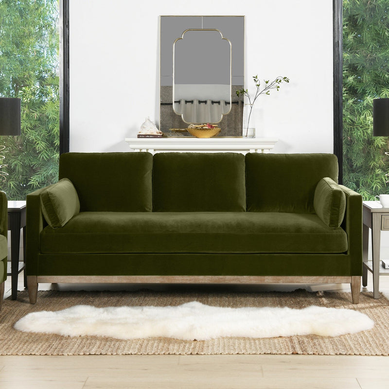 Modern farmhouse sofa in dark green fabric with rolled arms and three back cushions