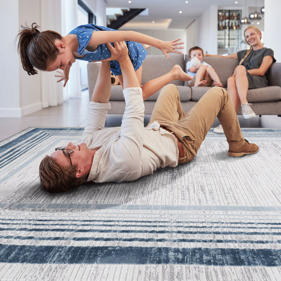 Bordered area rug with navy stripes and light textured field