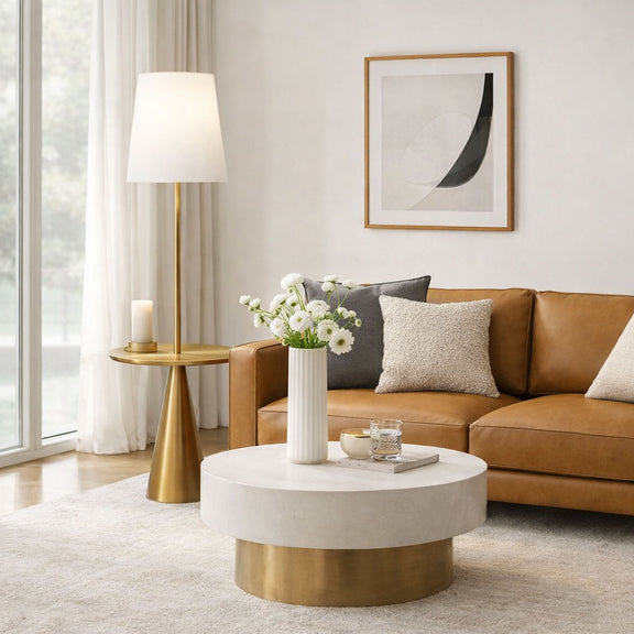 Modern floor lamp with white drum shade and round gold accent table
