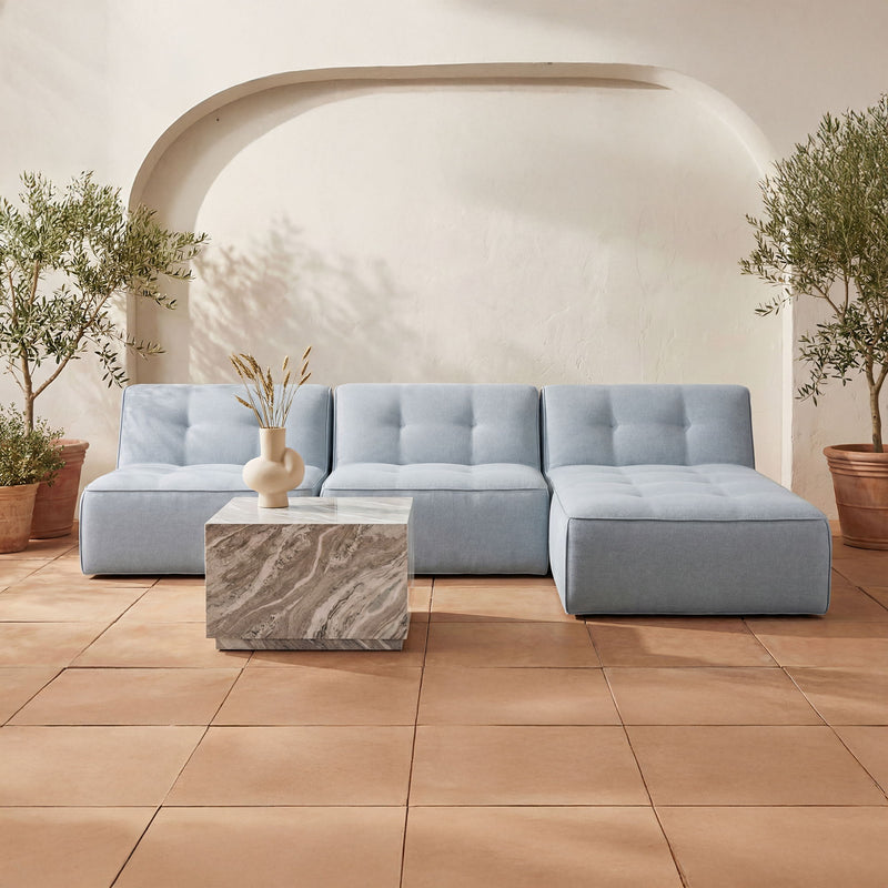 Light blue outdoor slipper sofa with tufted back and two matching ottoman seats