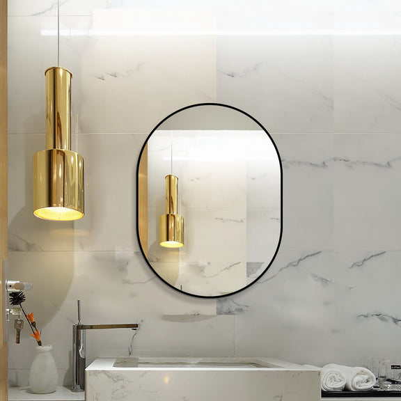 Black-framed oval bathroom mirror with reflective surface on tiled wall