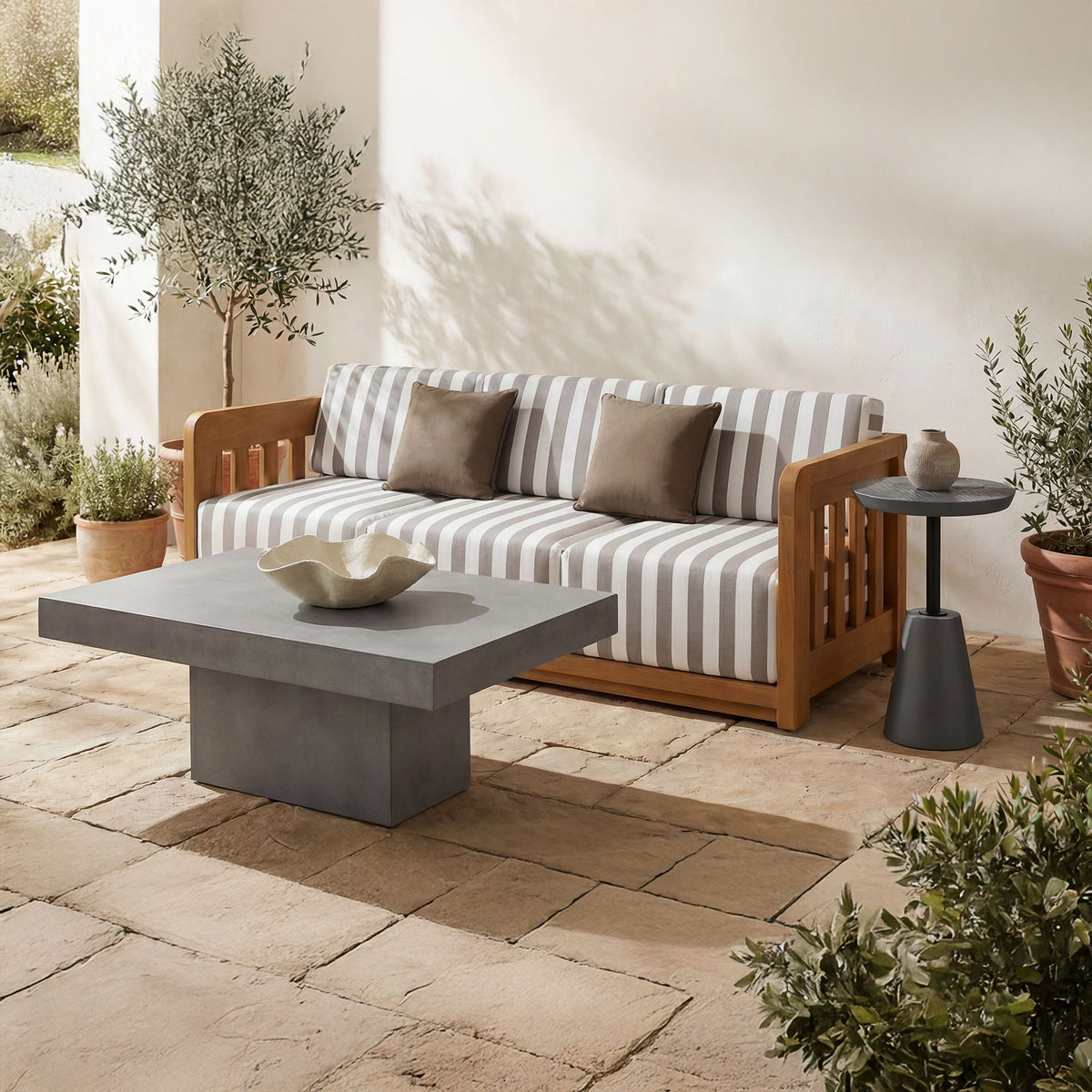 Cement gray outdoor coffee table with square top and low pedestal base.